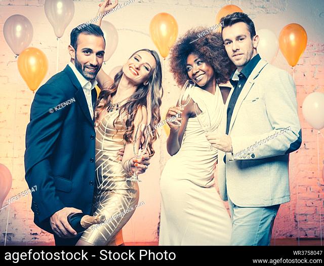 Group of women and men celebrating new years eve or a birthday with champagne