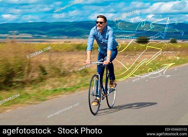 Young cyclist in casual clothing with fabulous nature background
