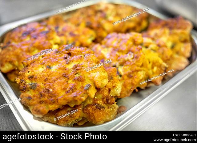 Fried chicken chops in batter are laid out for serving. Close-up of delicious and appetizing food. Background