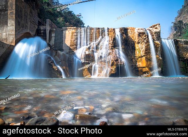 Smooth Long Exposure of Waterfall. Creamy Beautiful waterfall falling off a cliff in the mountas