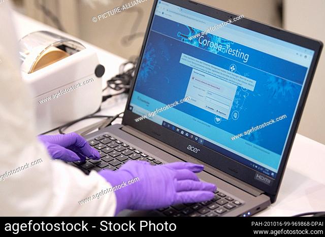 16 October 2020, Saxony, Dresden: A member of staff from the Fraunhofer-Gesellschaft is working on a laptop during a press event to present a corona test mobile...