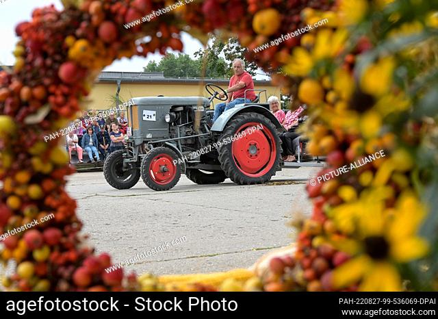 27 August 2022, Saxony-Anhalt, Bernburg: During the technology parade, this historic Schlüter tractor was also demonstrated to the public