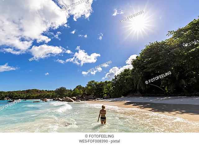 Seychelles, Praslin, Anse Lazio, beach, female tourist in water