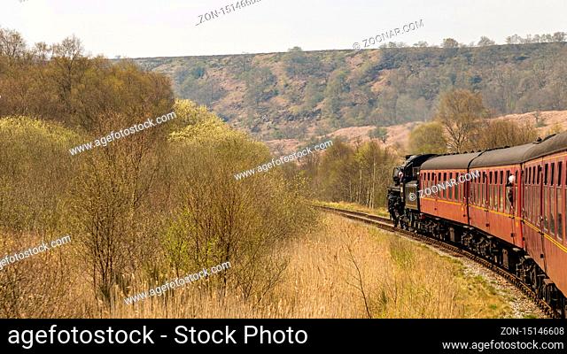 Near Goathland, North Yorkshire, England, UK - May 07, 2016: A train on the The North Yorkshire Moors Railway on the way between Whitby and Pickering