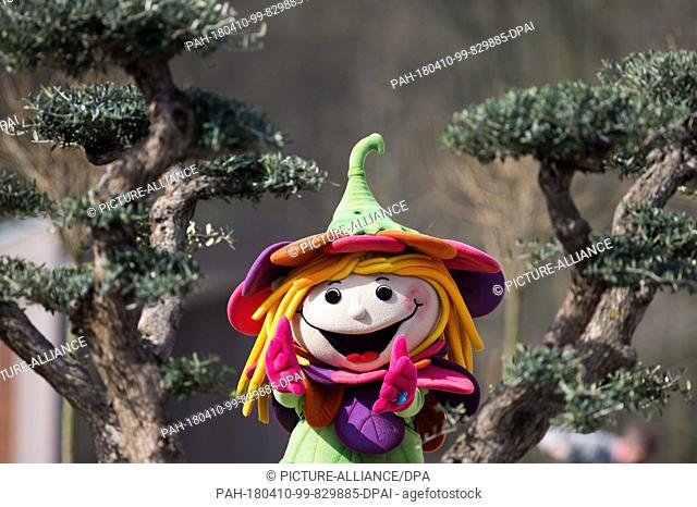 10 April 2018, Germany, Bad Iburg: The National Garden Show's mascot Rosalotta sits on the trunk of a small tree. The exhibit will run from 18 April to 14...