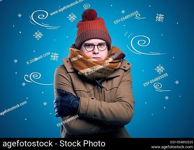Young hipster frozen boy with doodled snowflakes and windy concept