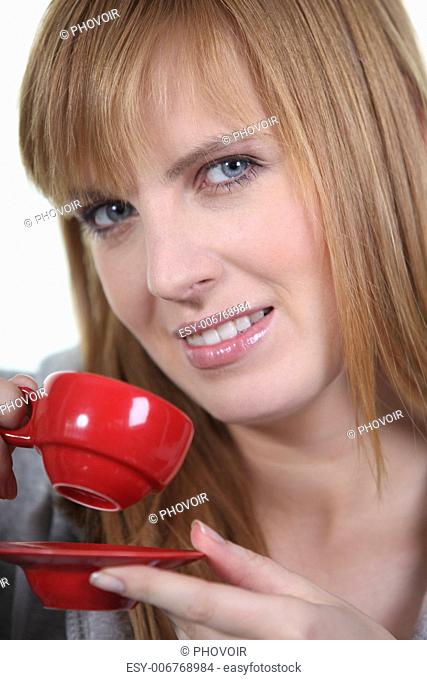 magnificent ginger woman drinking cup of coffee