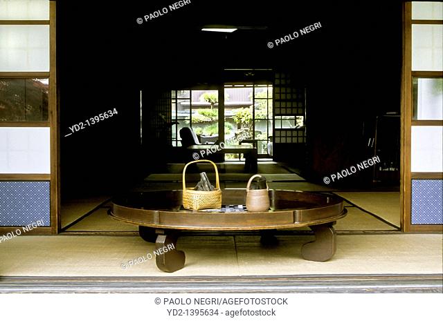 round table with bambu basket and binchotan charcoal, private house, Japan