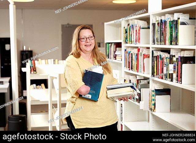 Portrait of librarian holding a book