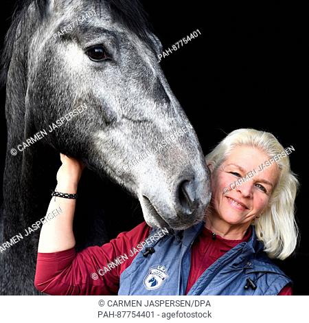 Carmen Hanken, the widow of Tamme Hanken, stands stands in a stall with the horse 'Grey Eminenze' at Hankenhof - Tamme in Filsum, Germany, 02 February 2017