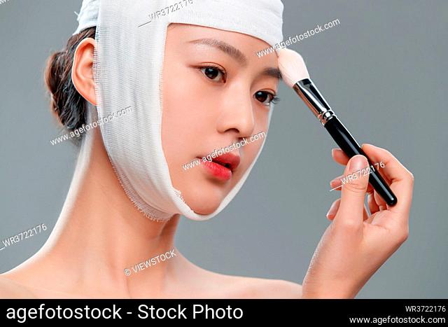 The pretty woman wearing a bandage makeup