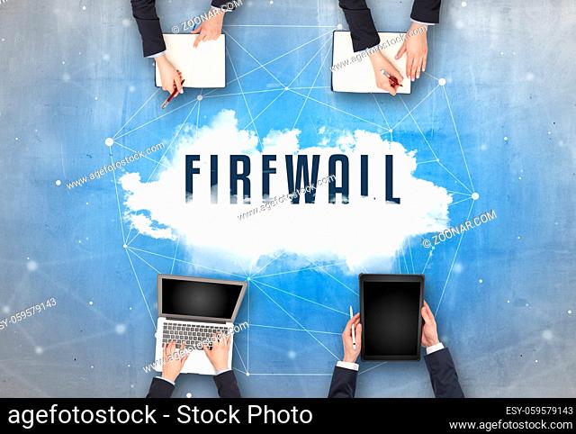 Group of people having a meeting with FIREWALL insciption, web security concept