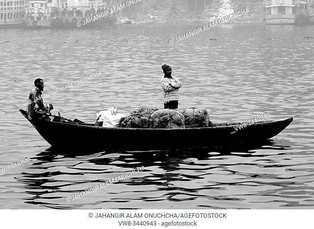 Bangladesh â. “ January 06, 2014: Boatmen carry passengers in foggy winter afternoon on River Buriganga
