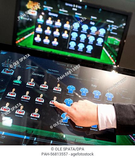 A trade fair visitor selects a player on the graphic surface of a software for soccer game analysis, manufactured by SAP