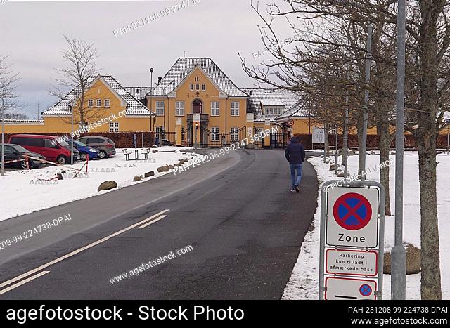 02 December 2023, Denmark, Sandholm: A man walks along a road towards the Sandholm reception center. If you want to apply for political asylum in Denmark
