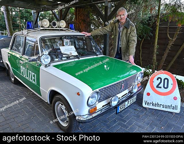 PRODUCTION - 19 January 2023, Brandenburg, Eggersdorf: Christian Paul, collector, stands next to his Lada 2100S built in 1985