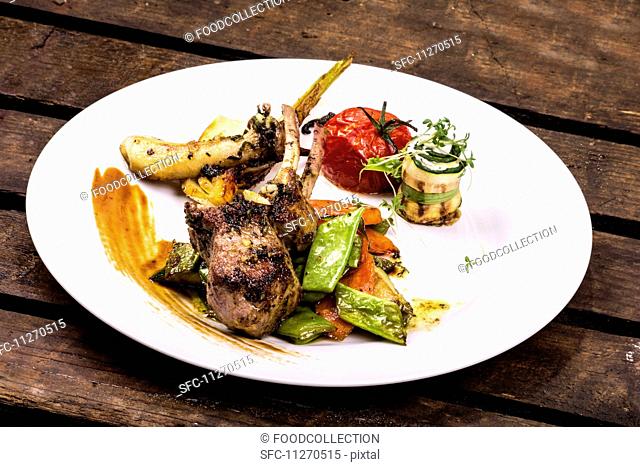 A lamb chop served with Mediterranean vegetables