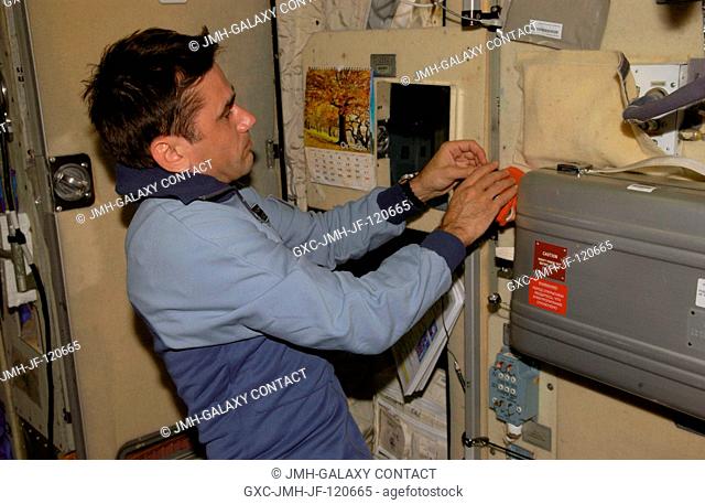 Cosmonaut Yuri I. Malenchenko, Expedition 16 flight engineer representing Russia's Federal Space Agency, places hybridizers in orange Rekomb-kit in the Zvezda...