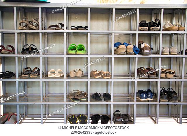 Temple visitors leave their shoes outside in cubicles