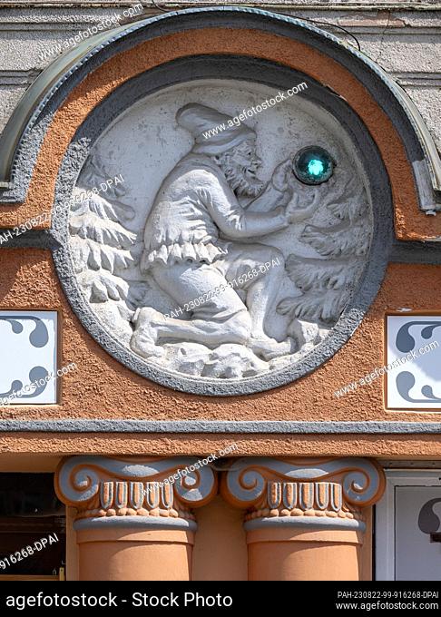 15 August 2023, Czech Republic, Jáchymov: A wall relief can be seen above the entrance to the former pharmacy in the center of the old mining town of Jáchymov...