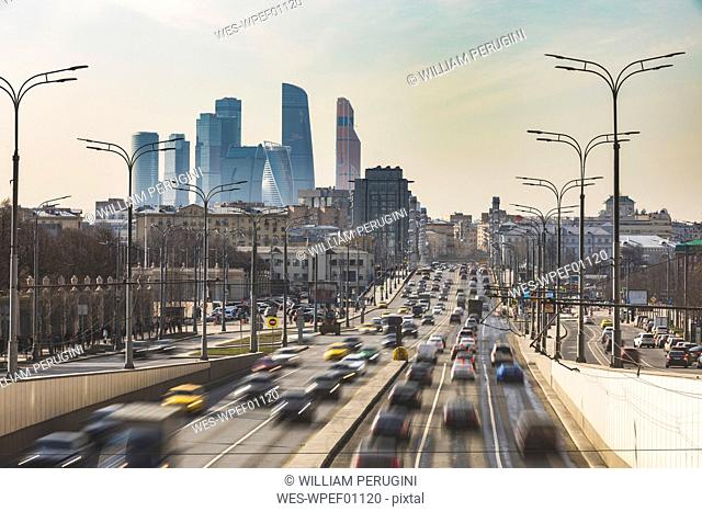 Russia, Moscow, Traffic on Krimsky Val with financial district in background