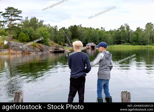 Boys fishing at lake