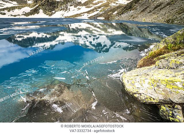 Ice crystals in the clear water of Lej da la Tscheppa during thaw, St. Moritz, Engadin, canton of Graubunden, Switzerland