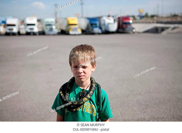 Boy with snake around his neck