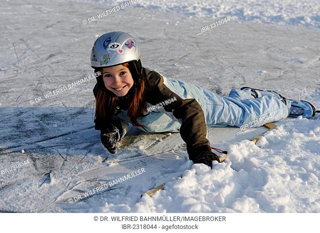 Girl has taken a fall during ice skating near St. Heinrich, Lake Starnberg, Five Lakes region, Upper Bavaria, Bavaria, Germany, Europe