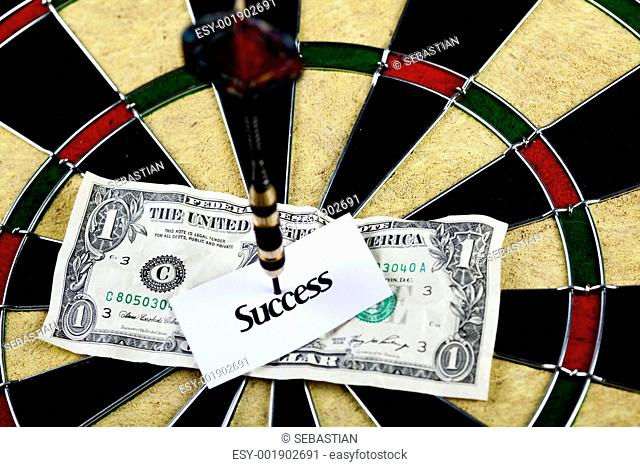 Darts target and dollar in bull's-eye