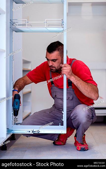 young professional worker installing a new stylish modern kitchen furniture