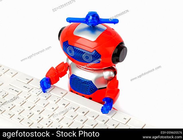 Toy robot and computer isolated on white background