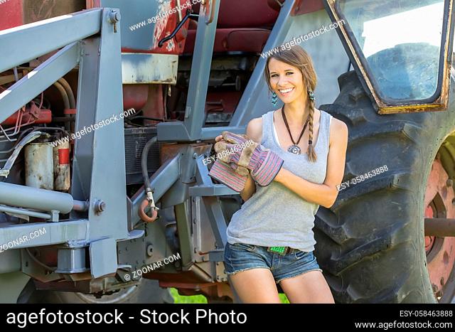 model posing as a farmers daughter in a rural environment