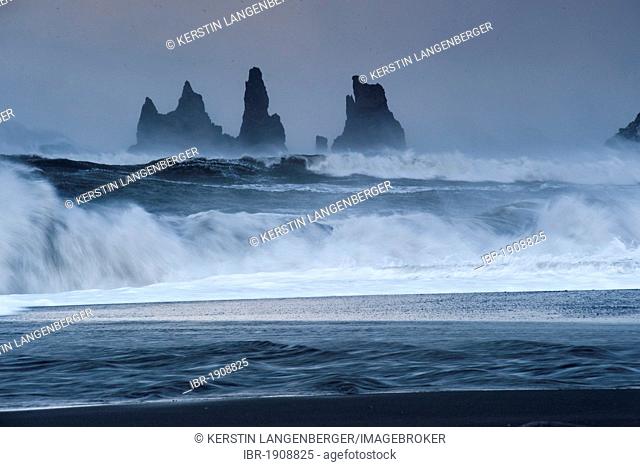 The Reynisdrangar pinnacles between by strong waves on the wintry Reynisfjara beach at Vik I Myrdal, Iceland, Europe