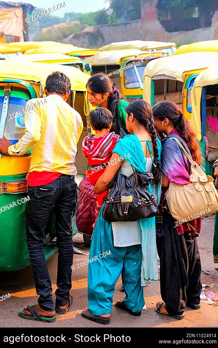 Local people waiting for a tuk-tuk at Kinari Bazaar in Agra, Uttar Pradesh, India. Agra is one of the most populous cities in Uttar Pradesh