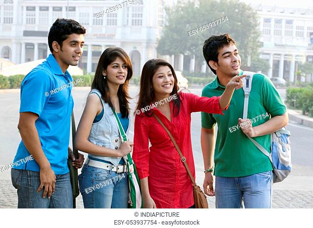 Group of happy college friends looking away