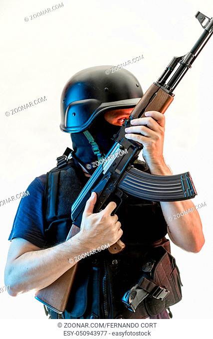 man armed with balaclava and bulletproof vest, gun and shotgun, kalashnikov