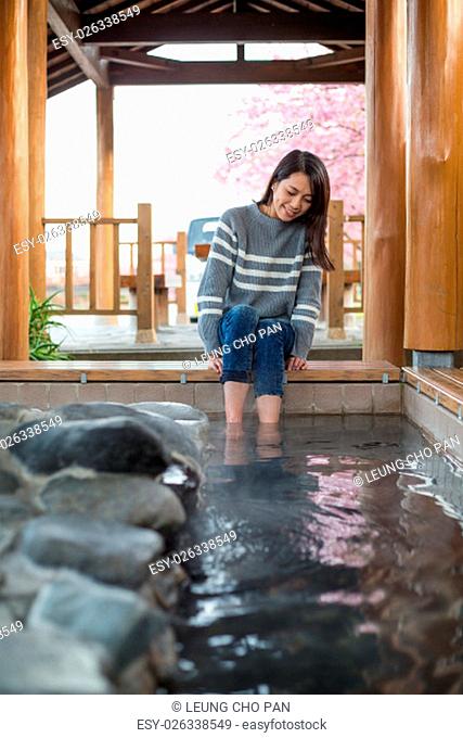 Woman feeling relax with her legs in onsen