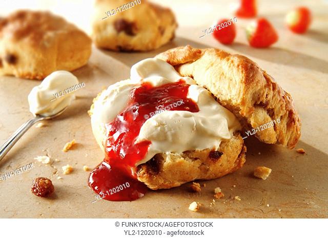 Traditional British scones with clotted cream and apricot jam