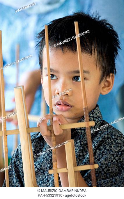 A former street kid plays with Indonesian musical instruments in Jakarta,  Indonesia, 03 November 2014. Actress Natalia Woerner supports Kindernothilfe