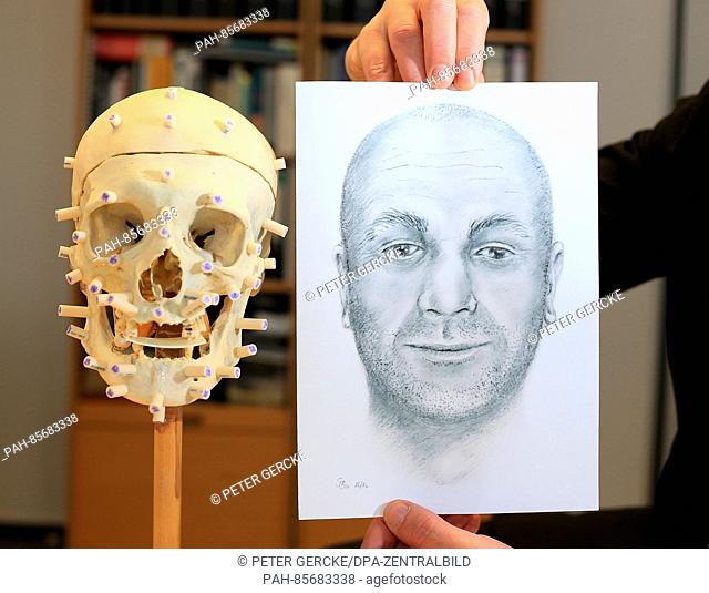 The skull of an unknown dead person, photographed next to a drawing of a identikit picture at the state criminal police agency in Magdeburg, Germany