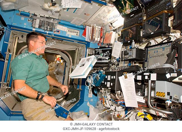 Astronaut Shane Kimbrough, STS-126 mission specialist, is pictured near the station's robotic Canadarm2 workstation in the Destiny laboratory of the...