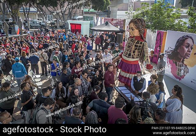 06 November 2023, Mexico, Tijuana: The doll ""Little Amal"" from the art project ""The Walk"" is used at the border with the USA. The 3