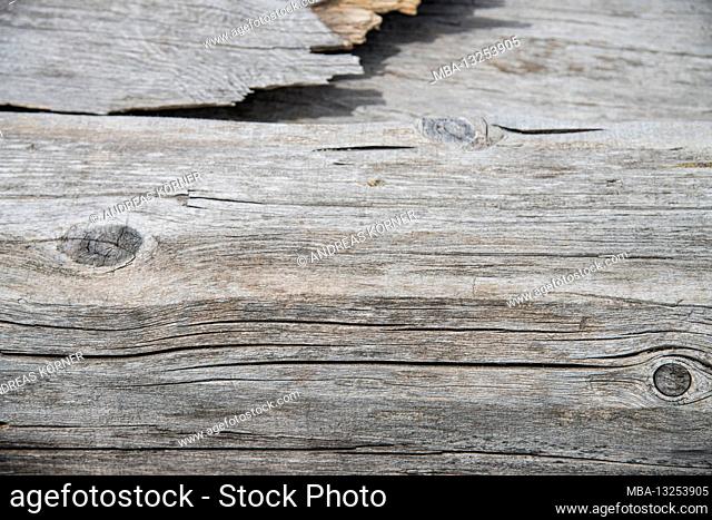 Detail of a faded wooden board with cracks