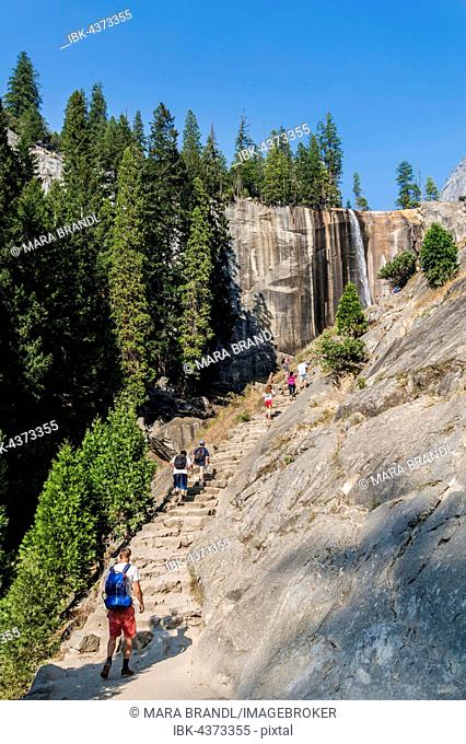 Young man on hiking trail to Vernal Fall, waterfall, Mist Trail, Yosemite Valley, Yosemite National Park, UNESCO World Heritage Site, California, USA
