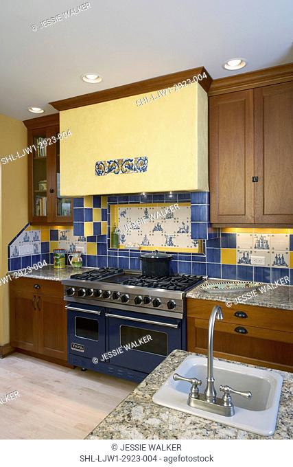KITCHENS: view of stove area, yellow exhaust hood, decorative use of ceramic tiles, yellow and blue tiles frame the blue and white hand painted tiles