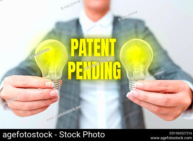 Inspiration showing sign Patent Pending, Word for Request already filed but not yet granted Pursuing protection Lady in business outfit holding two lamps...