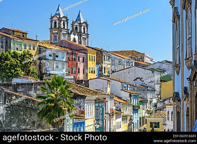 Colorful houses facades and historic church towers in baroque and colonial style with blue sky in the famous Pelourinho neighborhood of Salvador, Bahia