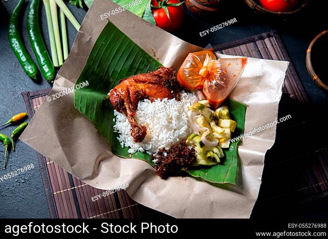 Nasi lemak kukus with chicken, popular traditional Malay local food. Flat lay top down overhead view