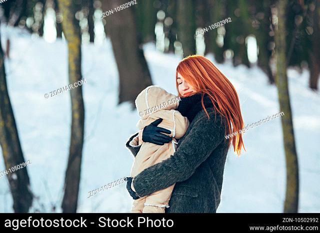Mom and baby in the park in winter